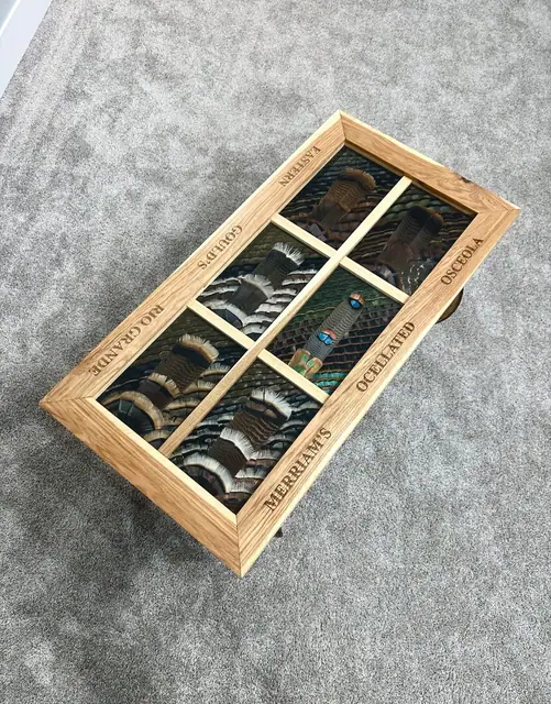 Custom turkey feather art table with feathers displayed under glass, built by All Feathers Taxidermy
