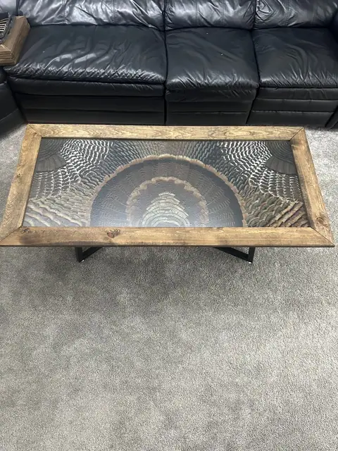 Custom turkey feather art table with feathers displayed under glass, built by All Feathers Taxidermy