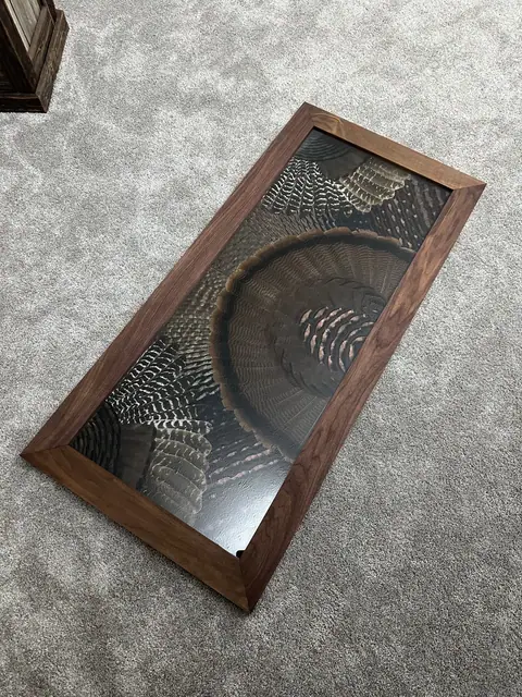 Custom turkey feather art table with feathers displayed under glass, built by All Feathers Taxidermy