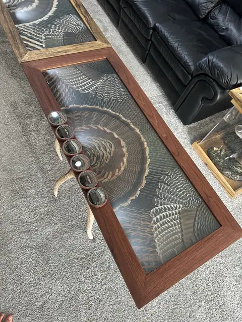 Custom turkey feather art table with feathers displayed under glass, built by All Feathers Taxidermy