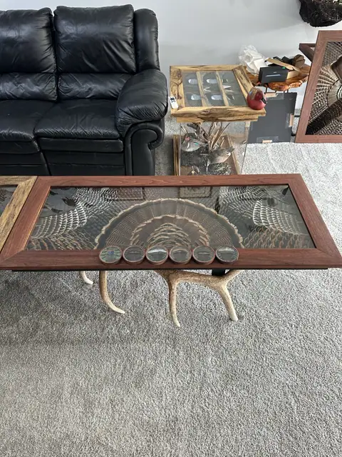 Custom turkey feather art table with feathers displayed under glass, built by All Feathers Taxidermy