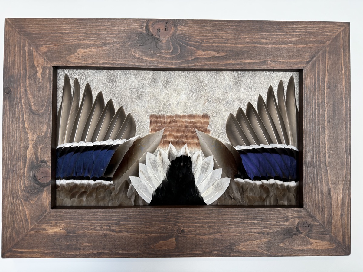 Student-built Waterfowl piece with blue-panel wings and carved centerpiece in a walnut frame
