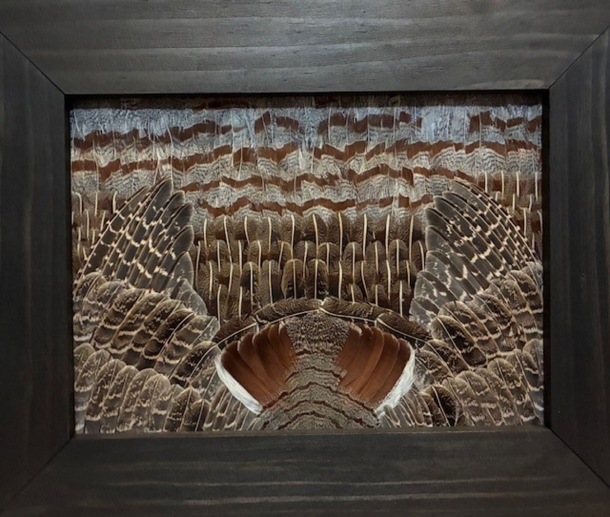 Close-up of a student-built Partridge piece in a dark walnut frame
