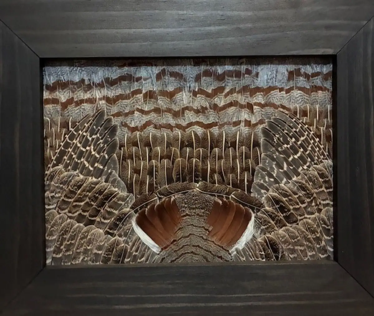 Close-up of a student-built Partridge piece in a dark walnut frame